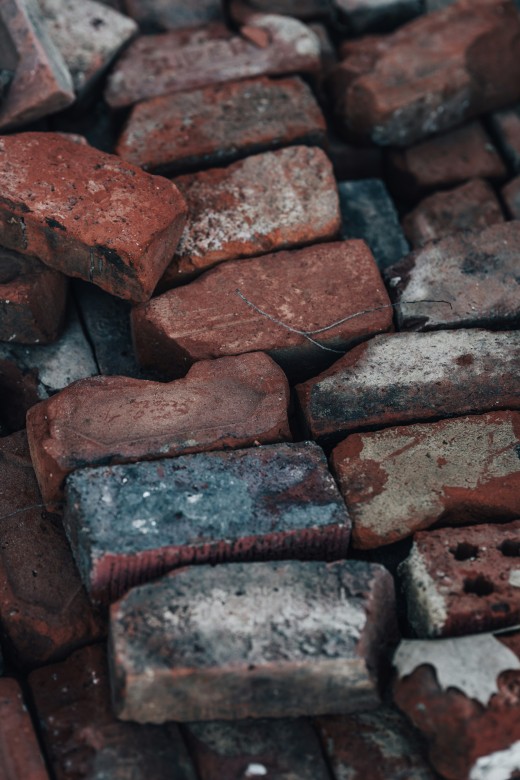 A pile of red bricks sitting next to each other