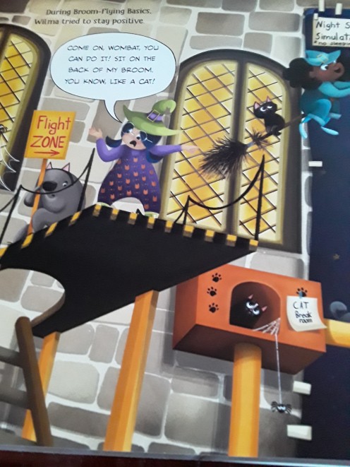 Teaching her wombat to sit on her broom