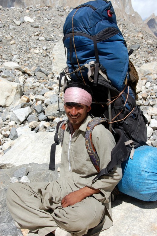 Seeing this guy so happy carrying this backpack to make a living, it is no wonder that some of us do the same for fun. On a second thought, he must be smiling because he could sit at last. 