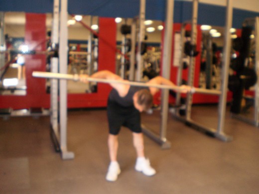 The Barbell Good Morning down position.