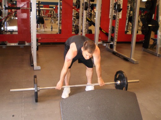 The Stiff Legged Barbell Row start position.