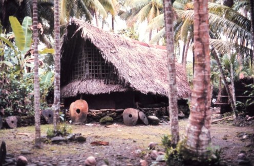 Traditional style structure with stone money indicating great wealth. Most stones were mined on Palau and carried by outrigger canoe some 450 kilometers (250 miles).