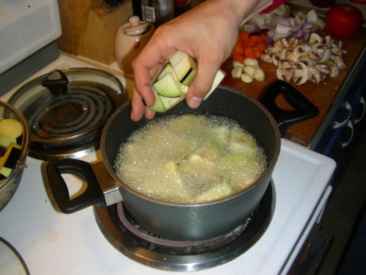 Start frying the eggplants in vegetable oil, till they barely start to turn golden yellow