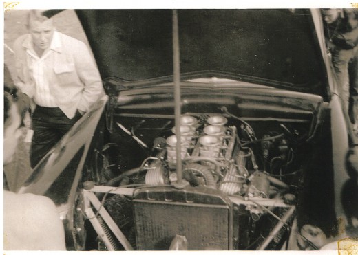 Under the hood, showing the "goods" of an unknown car.