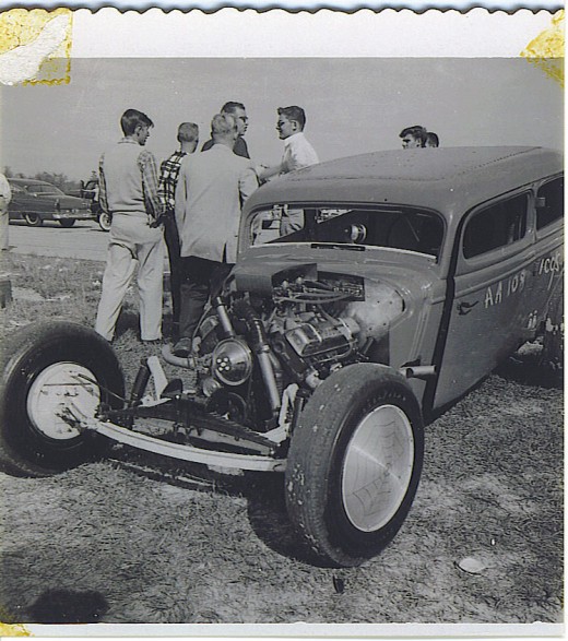 Unknown car and group of unknown drag racing buddies.