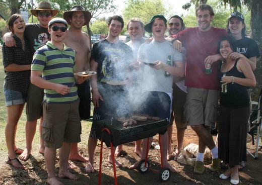Friends having fun in the sun with beer and braaivleis
