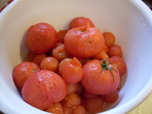 A bowl of just-blanched, skinned tomatoes.