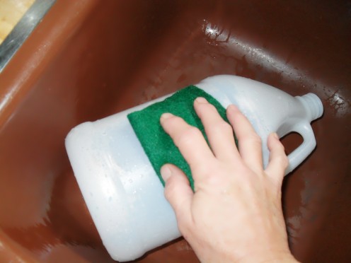 Wash away the excess glue with a scrub pad and then dry the bottle off