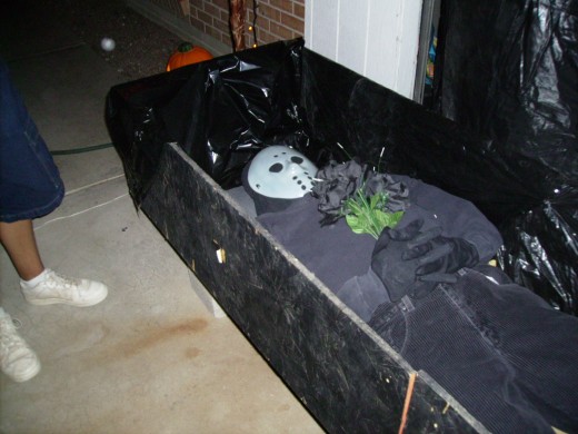 A zombie laying in its casket on Halloween