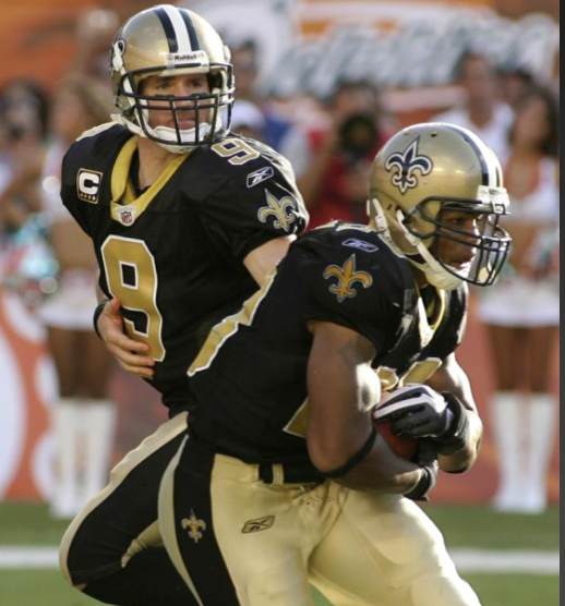 New Orleans Saints quarterback Drew Brees (9) hands off to running back Pierre Thomas during the second quarter of an NFL football game between the Miami Dolphins and the New Orleans Saints Sunday, Oct. 25, 2009 in Miami. (AP Photo/Jeffrey M. Boan)