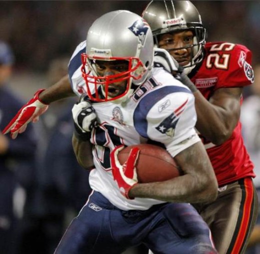 New England Patriots wide receiver Randy Moss (81) is caught from behind by Tampa Bay Buccaneers cornerback Aqib Talib (25) near the goal line after Moss caught a long first quarter pass before their NFL football game at Wembley Stadium in London, Su