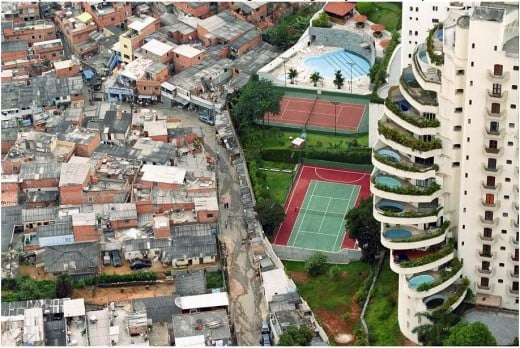 ...see the shanty town built right up to the wall in this San Paulo slum.... or is it a high des res area? Most of them in poverty,a few in luxury, the way of the world.