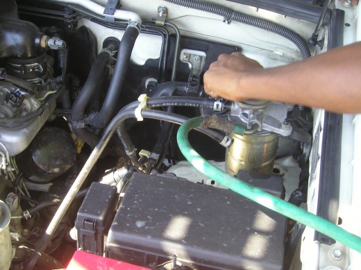 Manual flushing of adulterated fuel mixture.  Photos by Glendon Caballero.