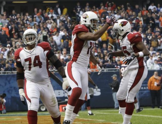 Arizona Cardinals WR #11 Larry Fitzgerald celebrates with teammates #15 Steve Breaston and  #74 Reggie Wells after making a touchdown-reception against the Chicago Bears 11/8/09 (AP Photo/Charles Rex Arbogast)