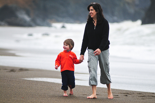 Happy mom and son enjoy the waves 