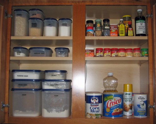 Storage containers for baking ingredients keep cupboard organized.