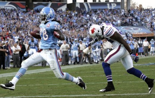 Tennessee Titans #28 Chris Johnson scores a touchdown on a one-yard run ahead of Buffalo Bills linebacker Nic Harris, right, Sunday, Nov. 15, 2009. (AP Photo/Wade Payne)
