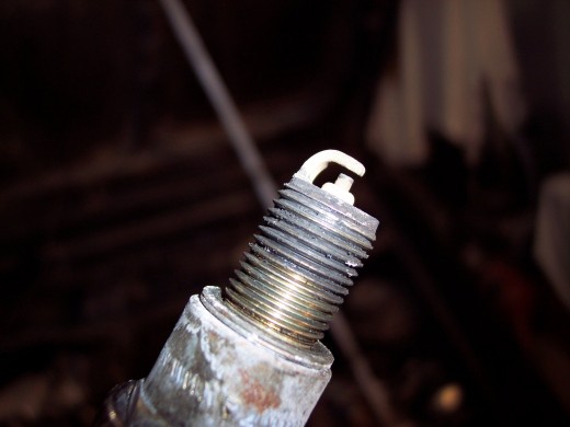 A properly running engines spark plug should have a brown or reddish colored electrode.  If the electrode is black, the car is running too rich.  If its white, its running too lean.
