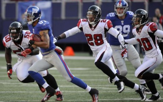 New York Giants wide receiver Domenik Hixon (87) runs for a first down against Atlanta Falcons linebacker Curtis Lofton (50), safety Thomas DeCoud (28) and cornerback Brent Grimes (20) during the first quarter of an NFL football game, Sunday, Nov. 22