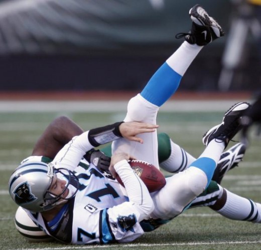 Jake Delhomme (17) is sacked by New York Jets linebacker David Harris (52) in the first quarter during an NFL football game Sunday, Nov. 29, 2009, in East Rutherford, N.J. (AP Photo/Seth Wenig)