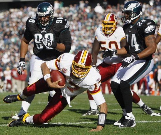 Washington Redskins' Jason Campbell (17) dives for a touchdown as Philadelphia Eagles' Mike Patterson (98) and Sheldon Brown (24) defend in the first half of an NFL football game, Sunday, Nov. 29, 2009, in Philadelphia. (AP Photo/Matt Slocum)