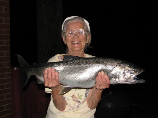 Mom is Proud To Hold A Large Salmon Caught From Lake Michigan
