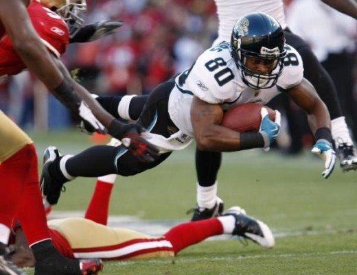 Mike Thomas (80) leaps after a reception against the San Francisco 49ers in the third quarter of an NFL football game in San Francisco, Sunday, Nov. 29, 2009. (AP Photo/Paul Sakuma)