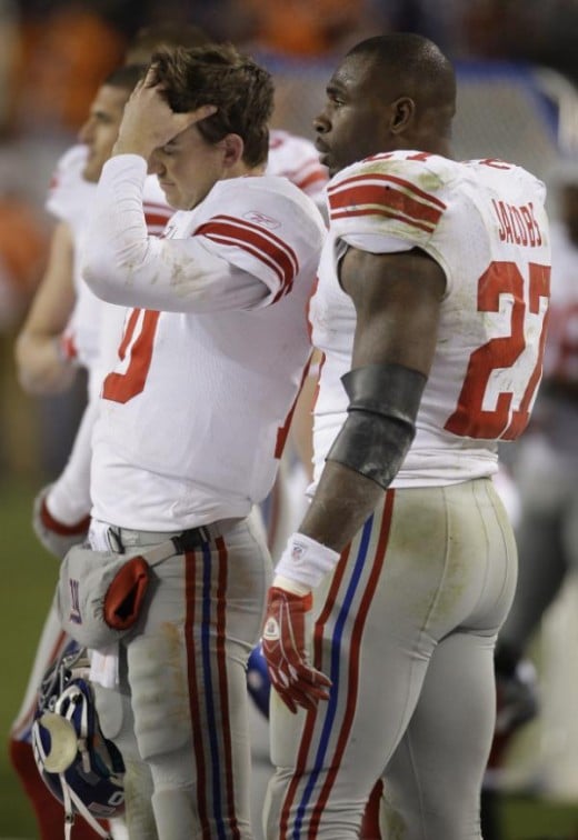 Brandon Jacobs (27) talks with quarterback Eli Manning (10) during the fourth quarter of an NFL football game against the Denver Broncos in Denver, Thursday, Nov. 26, 2009. Denver won 26-6. (AP Photo/Darron Cummings)