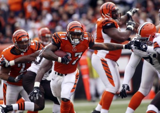 Larry Johnson (27) breaks through the line during the first half of their NFL football game against the Cleveland Browns in Cincinnati, Sunday, Nov. 29, 2009. (AP Photo/Tony Tribble)