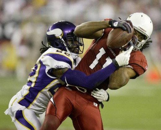 Arizona Cardinals wide receiver Larry Fitzgerald (11) pulls in a pass as Minnesota Vikings cornerback Benny Sapp defends during the first half of an NFL football game Sunday, Dec. 6, 2009 in Glendale, Ariz. (AP Photo/Paul Connors)