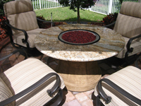 Custom built fire glass dining table fire pit with cranberry crushed glass.