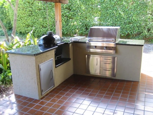 This outdoor kitchen has a Solaire Infrared gas grill and a ceramic kamado barbeque/smoker.