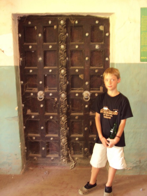 The intricately carved wooden door of the Boma