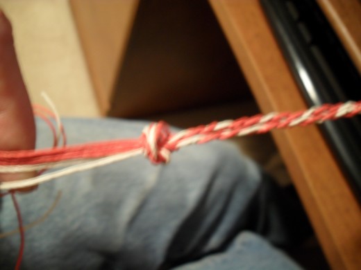 draw the knot very tight to finish the Hemp Valentine's Day Bracelet