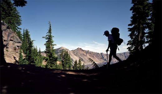 Jondolar walks in the shade of the trees along the crater's rim.