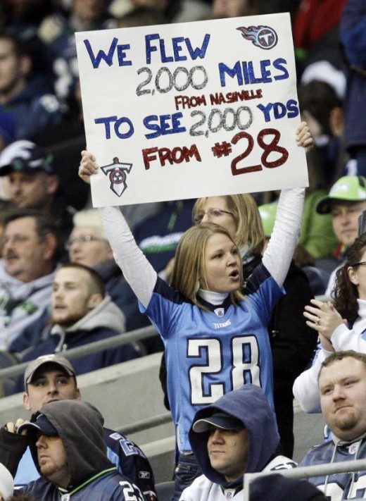 A fan in the stands celebrates the rushing performance of Tennessee Titans' Chris Johnson during the second half of an NFL football game against the Seattle Seahawks, Sunday, Jan. 3, 2010, in Seattle. (AP Photo/Elaine Thompson)