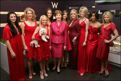 Former first Lady Laura Bush poses with celebrities in the Red Dress Collection Celebrity Fashion Show Friday, Feb. 2, 2007 to combat heart disease. (Photos public domain.)