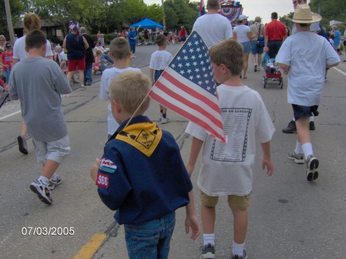 Boy Scouts marching in a Fourth of July Parade.