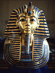 Gold burial mask of Tutankhamun, inlaid with turquoise, lapis lazuli, carnelian and coloured glass - wikimedia.commons