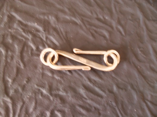 The style of a fish hook clasp is changed by the way the hook is bent to fit the necklace jewelry design.