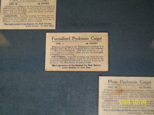 Catgut.  Surgical sutures preserved in paper packaging.