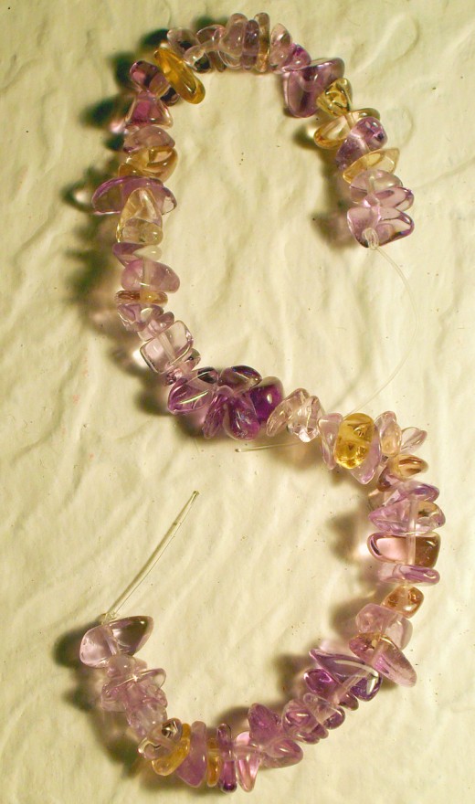 This strand 4mm Amethyst chips shows the variance of color and shape found in natural bead material.