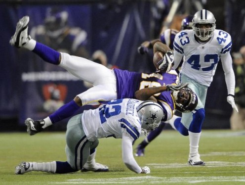 Dallas Cowboys' Orlando Scandrick (32) tackles Minnesota Vikings' Sidney Rice (18) after a catch during the second half of an NFL divisional playoff football game Sunday, Jan. 17, 2010, in Minneapolis. (AP Photo/Hannah Foslien)