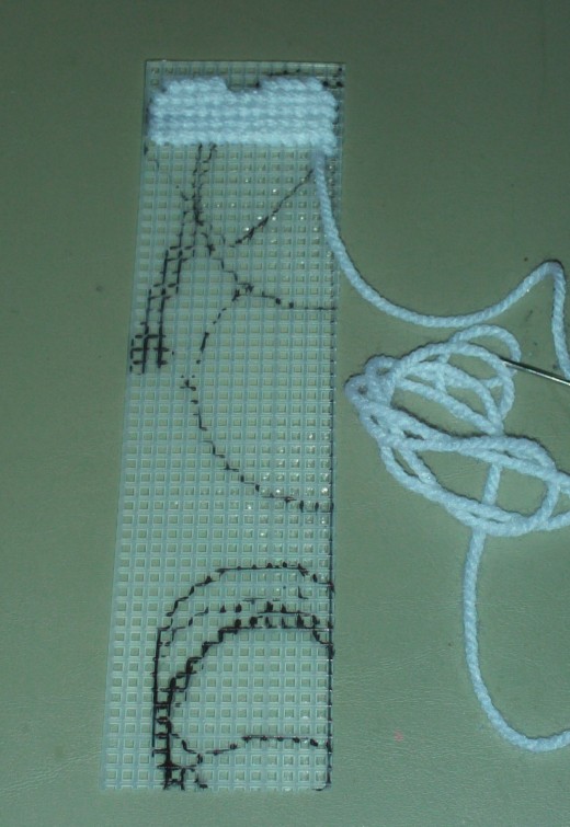 Here I continue to stitch in the white heart, which will look nice with the pink background as a contrast.