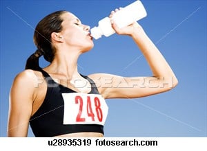 Portrait of a female athlete drinking form a water bottle