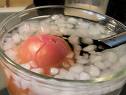 Cool your tomato off in an ice bath, and easily remove it with a slotted spoon.