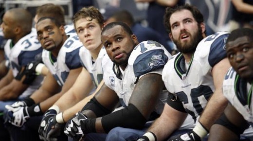 Members of the Seattle Seahawks offensive line, including Ray Willis (74) and Max Unger, second from right, sit on the bench during the fourth quarter of an NFL football game against the Houston Texans, Sunday, Dec. 13, 2009, in Houston. (AP Photo/Da