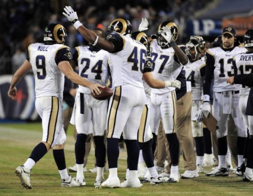 St. Louis Rams quarterback Keith Null (9) is congratulated by teammates Ronald Bartell (24), Daniel Fells (46), and James Butler (37) after Null threw his first career touchdown pass in the fourth quarter of an NFL football game against the Tennessee