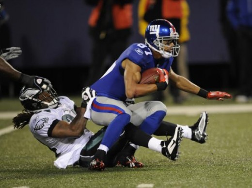 New York Giants' Domenik Hixon, right is tackled by Philadelphia Eagles' Eldra Buckley during the first quarter of an NFL football game Sunday, Dec. 13, 2009, in East Rutherford, N.J. (AP Photo/Henny Ray Abrams)