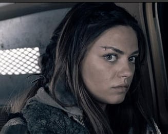 Mila Kunis as Solara, about to blow up an armored truck with a grenade - just one of the super violent scenes in Book of Eli.